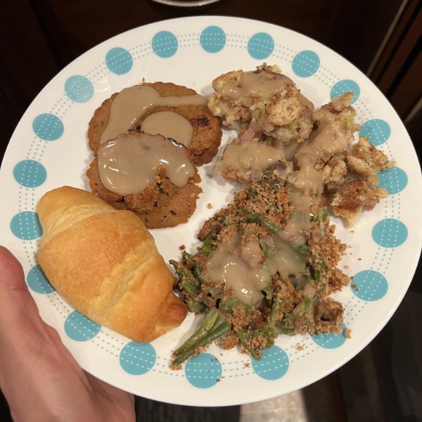 a small vegan thanksgiving meal on a with plate wit blue accents.