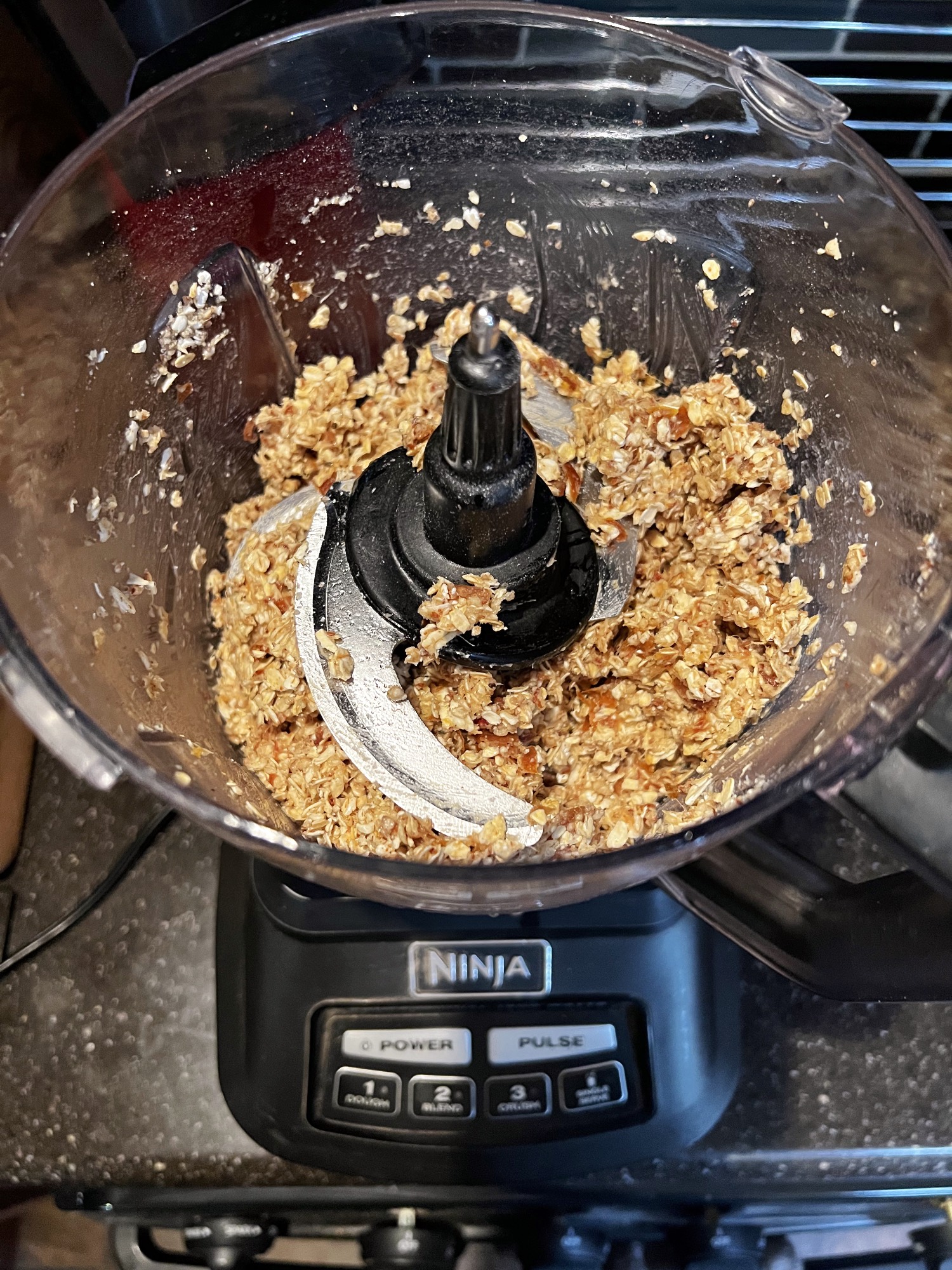 vegan glutenfree crust ingredients in a food processor bowl after processing.