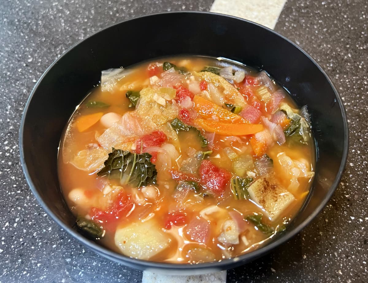 ribollita soup from how not to diet in a black bowl.