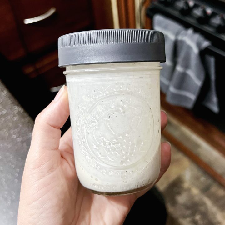 tahini sauce in a small mason jar.